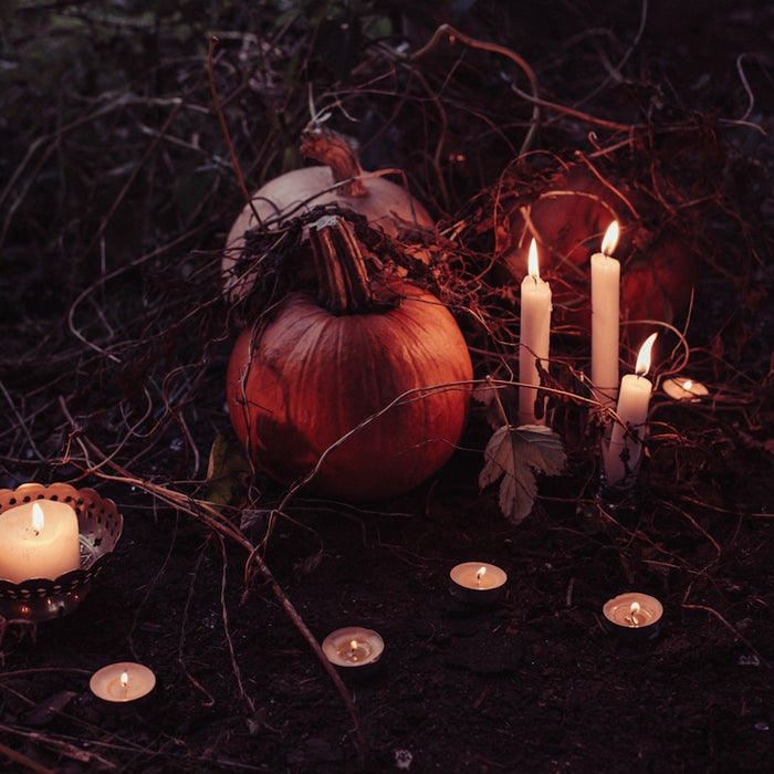 pumpkin between lighted candles