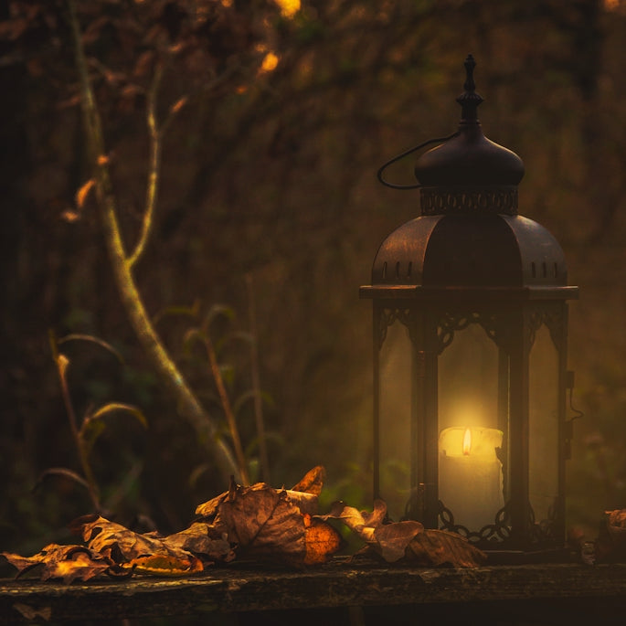 yellow pillar candle in black lantern