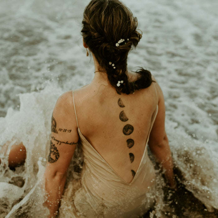 woman in brown tank top on water during daytime