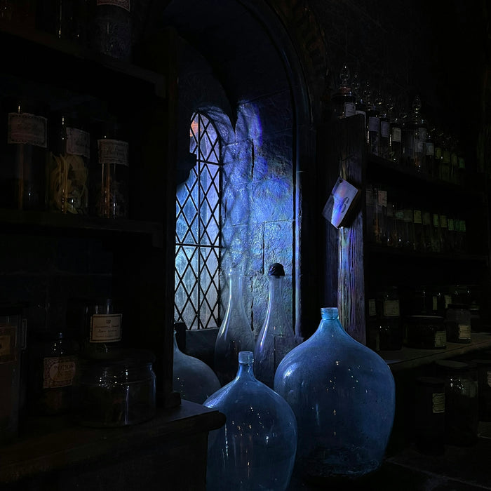 blue glass bottle on brown wooden shelf