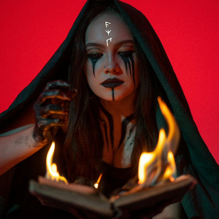 a woman with makeup on holding a book