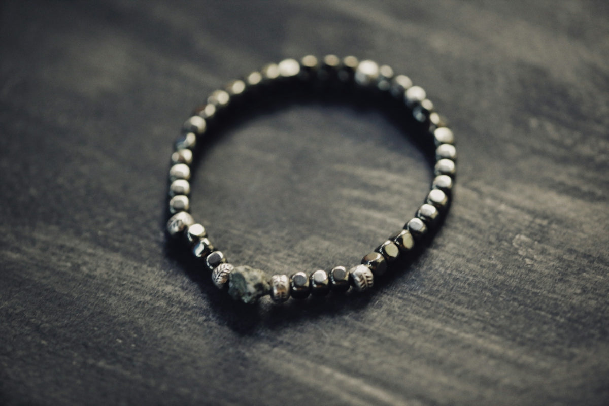 a beaded bracelet is sitting on a table