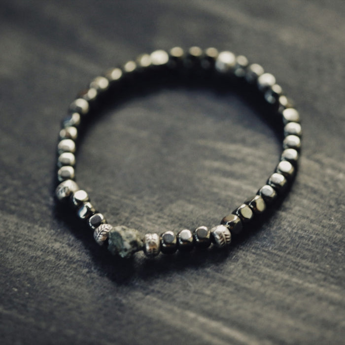a beaded bracelet is sitting on a table
