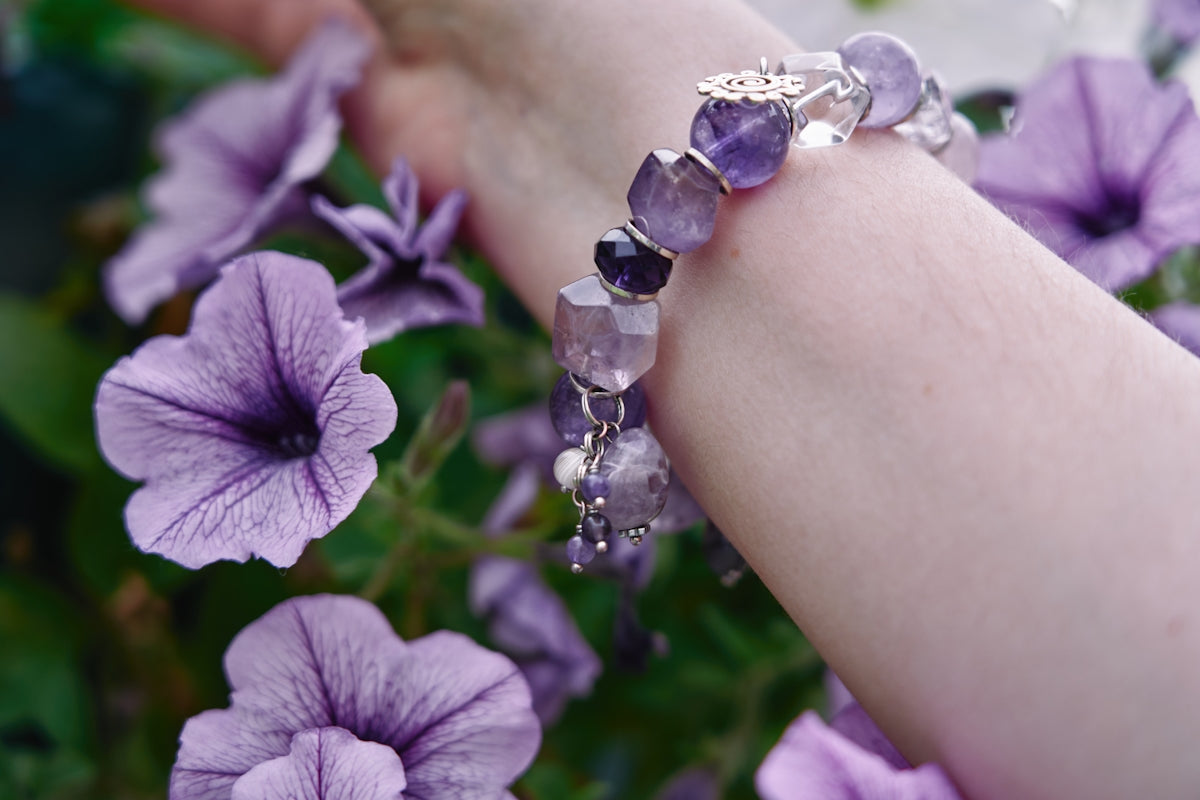 a close up of a person's arm with flowers in the background