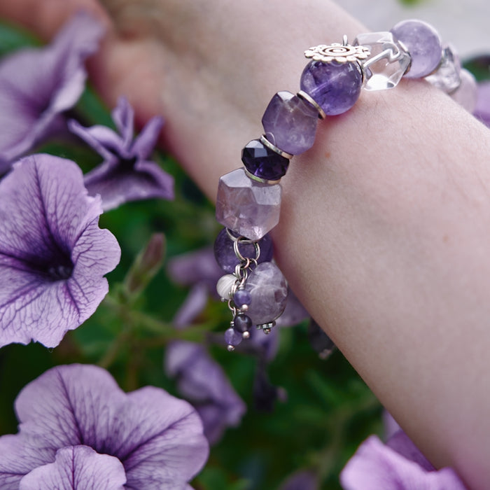 a close up of a person's arm with flowers in the background