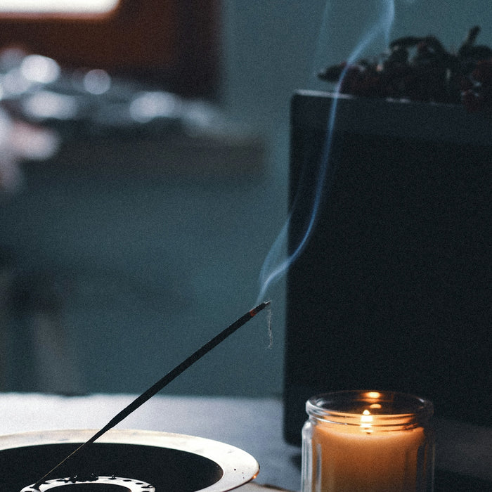a candle and a bowl on a table