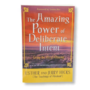 A book cover of 'The Amazing Power of Deliberate Intent' by Esther and Jerry Hicks, featuring a red and orange gradient background with a serene landscape and the setting sun.