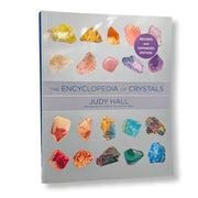 Book titled 'The Encyclopedia of Crystals' by Judy Hall with images of crystals on the cover.