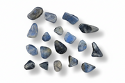 Set of blue stones with a ruler for scale on a white background