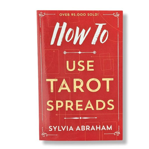 Book cover of 'How To Use Tarot Spreads' by Sylvia Abraham on a red background