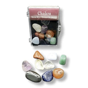 Chakra stone kit with colorful stones and a clear case on a white background