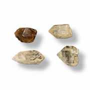 Four raw stones on a white background