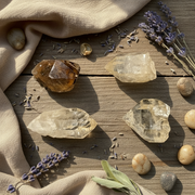Crystal stones and lavender on a wooden surface with beige fabric