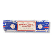 A long rectangular package of Satya Sai Baba Nag Champa Agarbatti incense sticks on a plain white background. The packaging is primarily blue with a large cream-colored central label featuring red text.