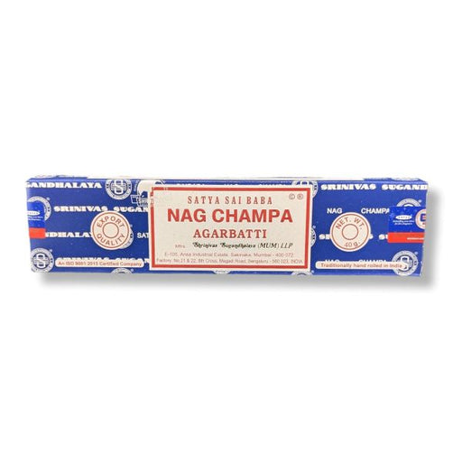 A long rectangular package of Satya Sai Baba Nag Champa Agarbatti incense sticks on a plain white background. The packaging is primarily blue with a large cream-colored central label featuring red text.