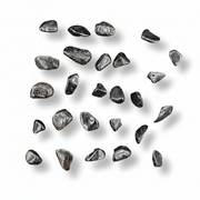 Collection of lodestones arranged in a scattered pattern on a white background