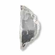 A raw, rough-cut clear selenite slab with natural crystalline structures and a dark inclusions area, shown on a clean white background.