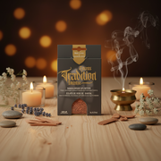 A package of Sandalwood Splinters incense by Sacred Scents is displayed on a wooden surface with lit candles, incense sticks, stones, and a brass incense burner with rising smoke, set against a dark background with warm bokeh lights.