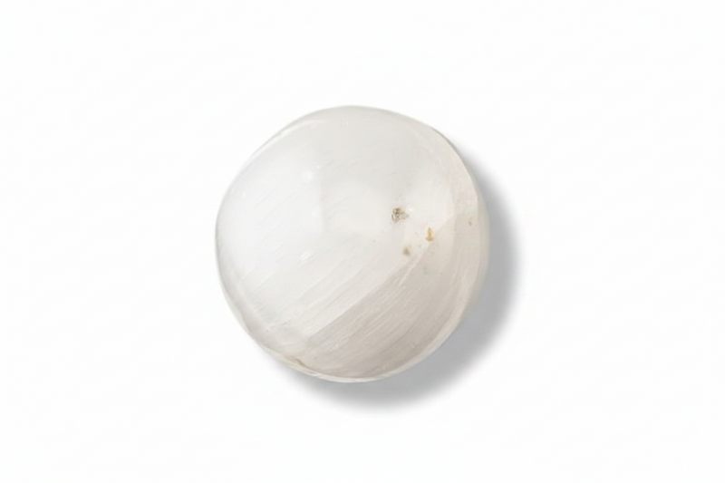 A selenite sphere on a white background