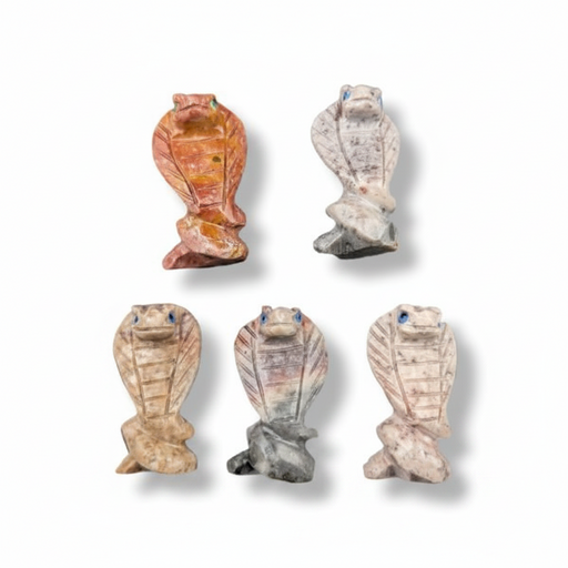 Five small carved cobra figurines in different stone-like colors, arranged on a plain white background with soft drop shadows.