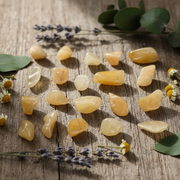 Yellow stones on a wooden surface with lavender and green leaves