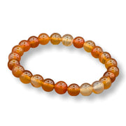 Beaded bracelet with orange and gold beads on a white background