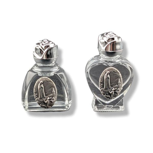 Two crystal bottles with silver lids on a white background