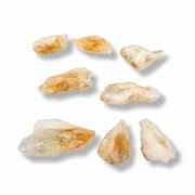 Raw citrine points on a white background