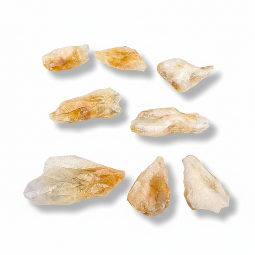 Raw citrine points on a white background