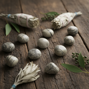 Marble-like stones and dried plants on a wooden surface
