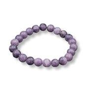 Purple beaded bracelet on a white background
