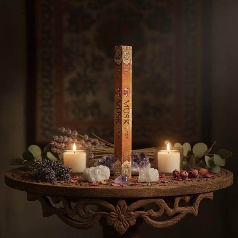 Pack of HEM Musk incense sticks on a table surrounded by crystals, dried flowers and candles 