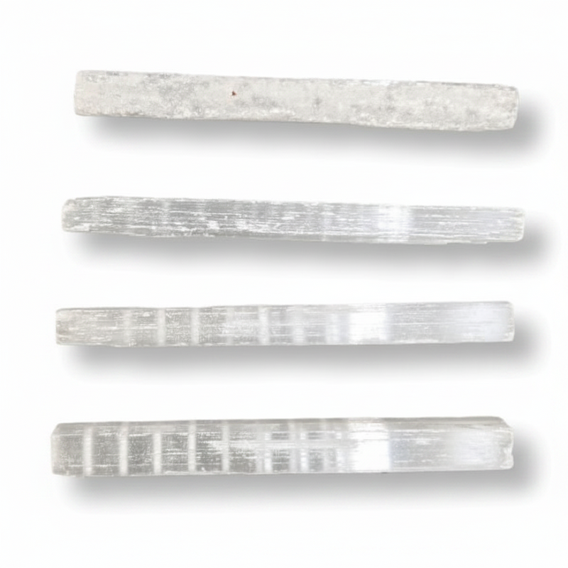 Four rectangular selenite rods arranged vertically on a white background, each showing natural striated texture and subtle color variation.