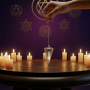 Angel Aura Quartz pendulum being used in a spiritual environment surround by candles 