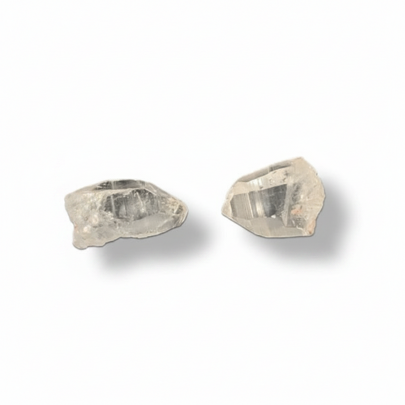Two raw lemurian quartz on a white background