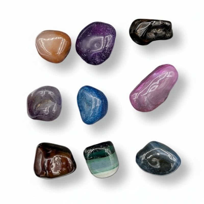 Multi coloured dyed agate tumbled on a white background