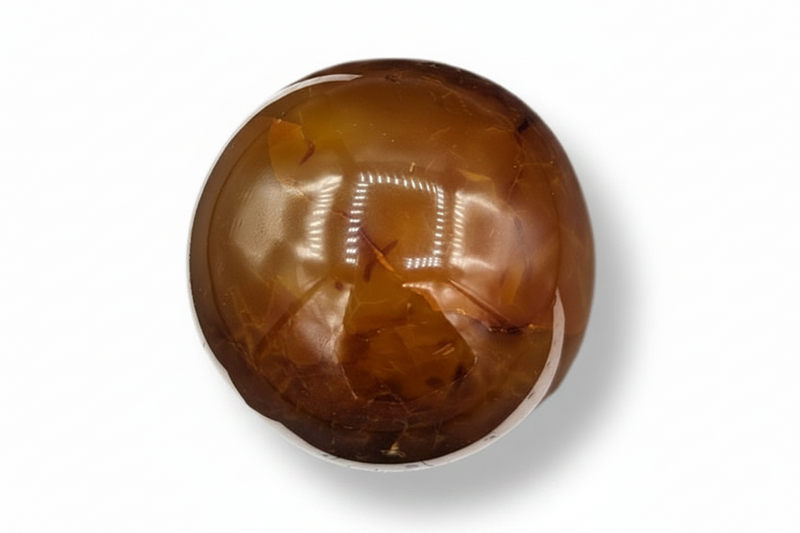 Round carnelian stone on a white background