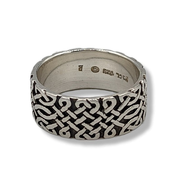 Silver ring with a black and white pattern on a white background