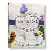 Book titled 'Mixing Essential Oils for Magic' by Sandra Kynes with images of essential oils on the cover.