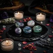 Fluorite Earthstones in a spiritual setting surrounded by other crystals, candles and dried flowers