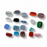Assorted colored glass stones on a white background