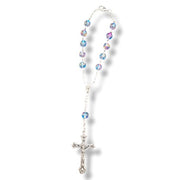 Rosary with multicolored beads and a silver cross on a white background