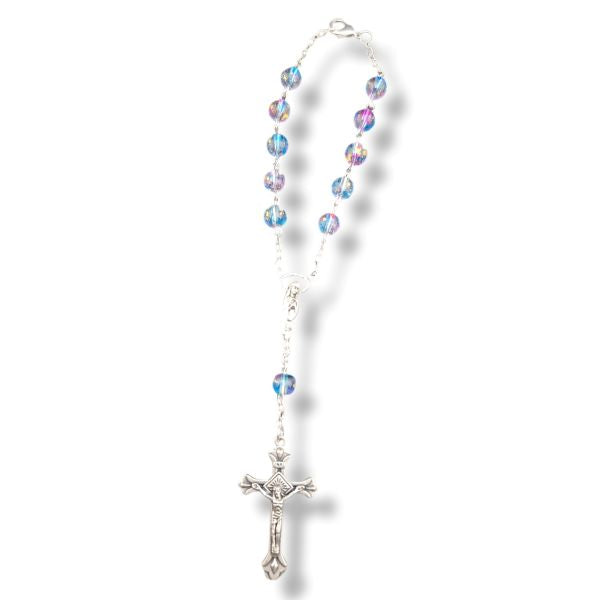 Rosary with multicolored beads and a silver cross on a white background