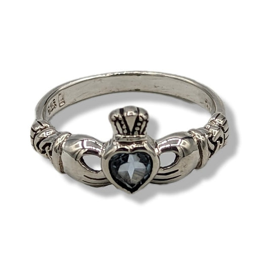 Silver claddagh ring with a heart-shaped stone on a white background