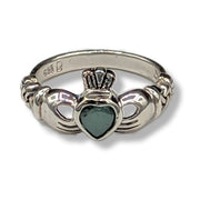 Silver ring with a heart-shaped stone on a white background