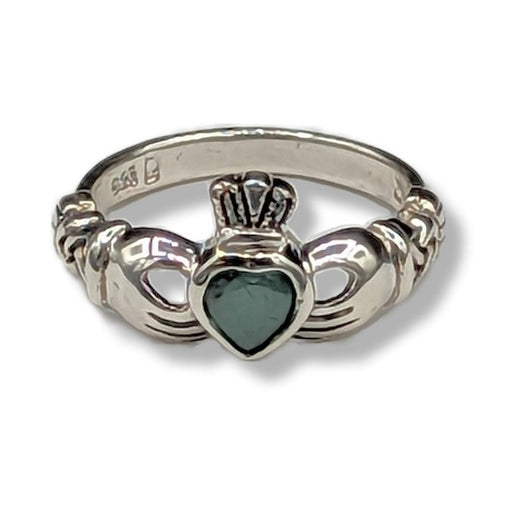 Silver ring with a heart-shaped stone on a white background