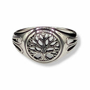 Silver ring with tree of life design on a white background