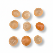 Orange spherical stones on a white background.