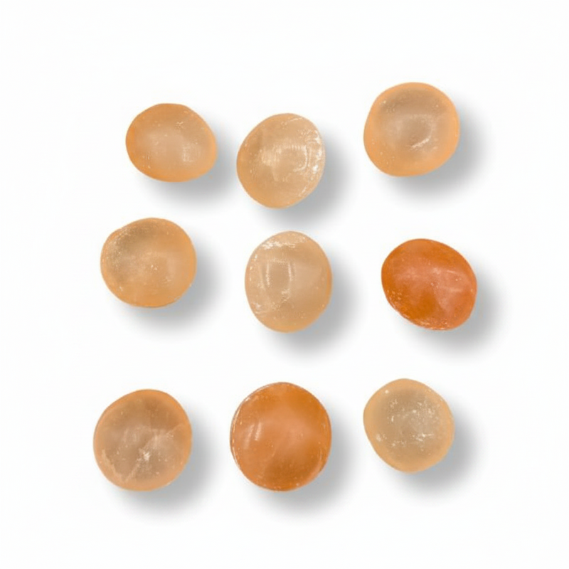Orange spherical stones on a white background.