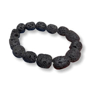 A beaded stretch bracelet made of dark, porous volcanic lava stones, displayed on a clean white background.